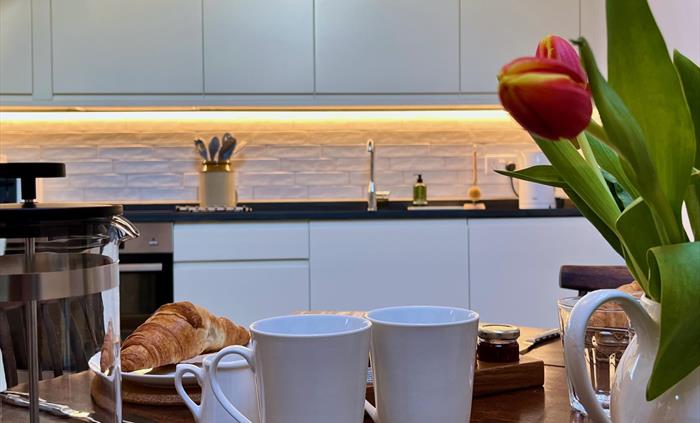 The open plan lounge includes a kitchen and dining area